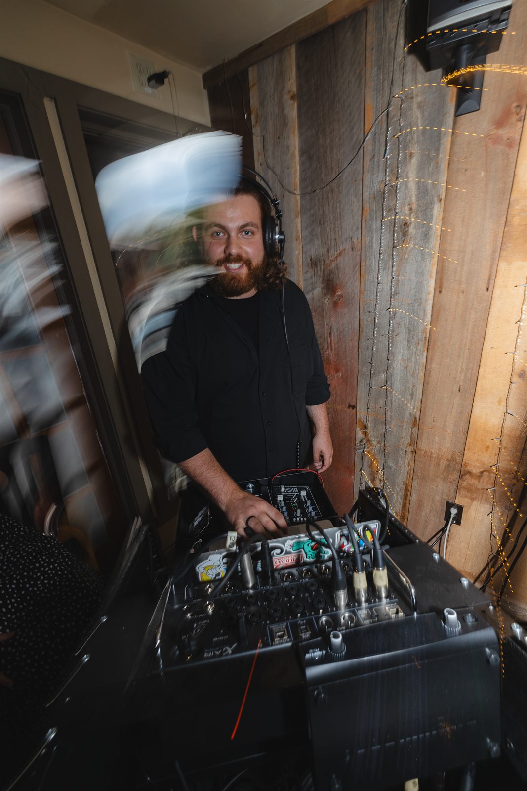 Cade — owner & DJ of Devo Productions, behind the mixing console
